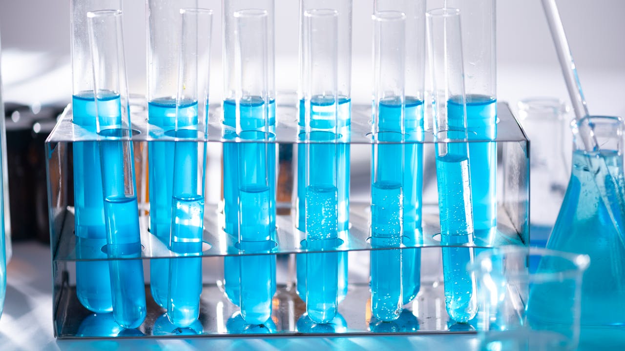 Premium supplement capsules and laboratory testing equipment on a clean surface
