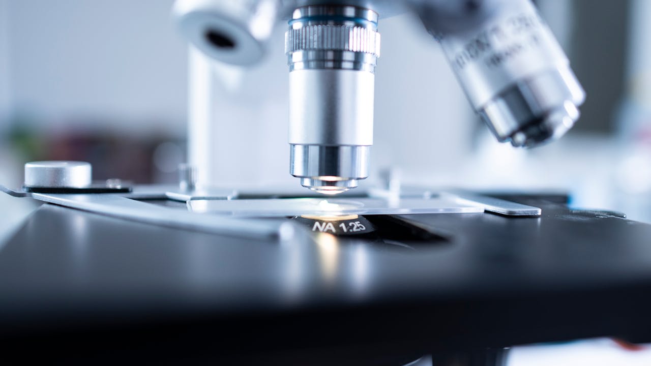 Scientific laboratory setting with microscope and research equipment representing quality testing