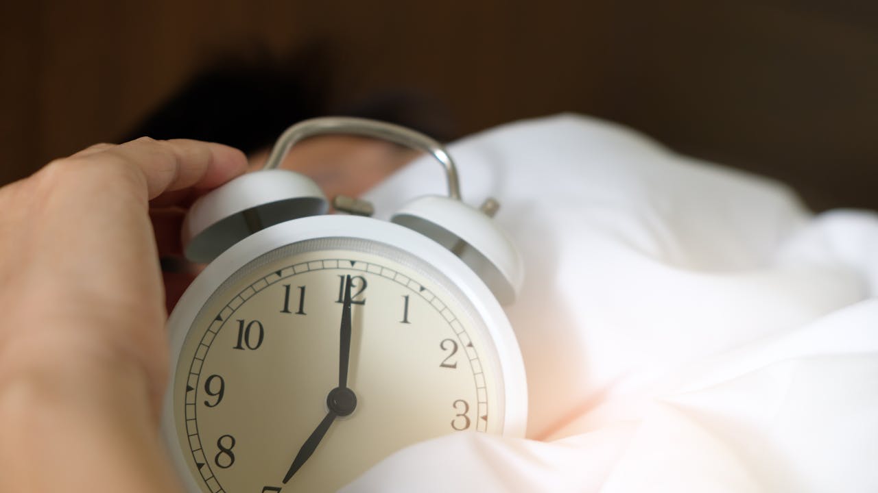 Person sleeping deeply in a well-made bed, peaceful and restful