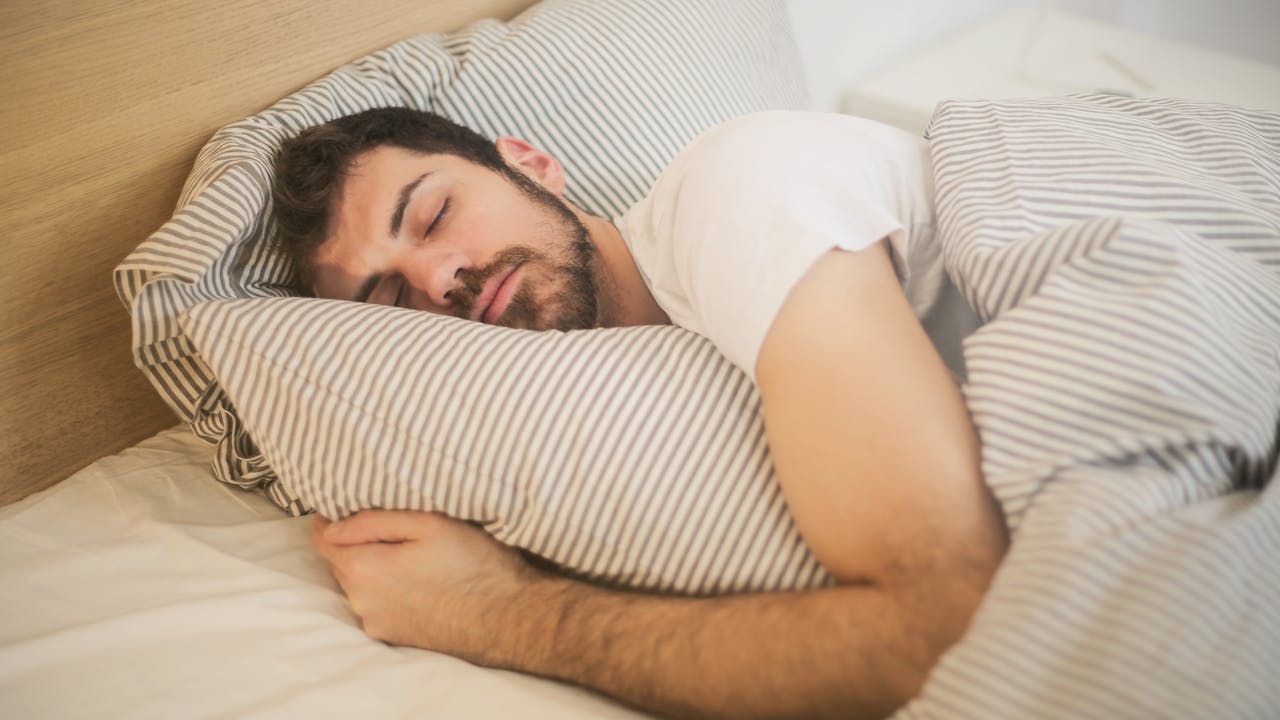 Person sleeping peacefully, representing glycine's evidence-backed sleep quality improvements