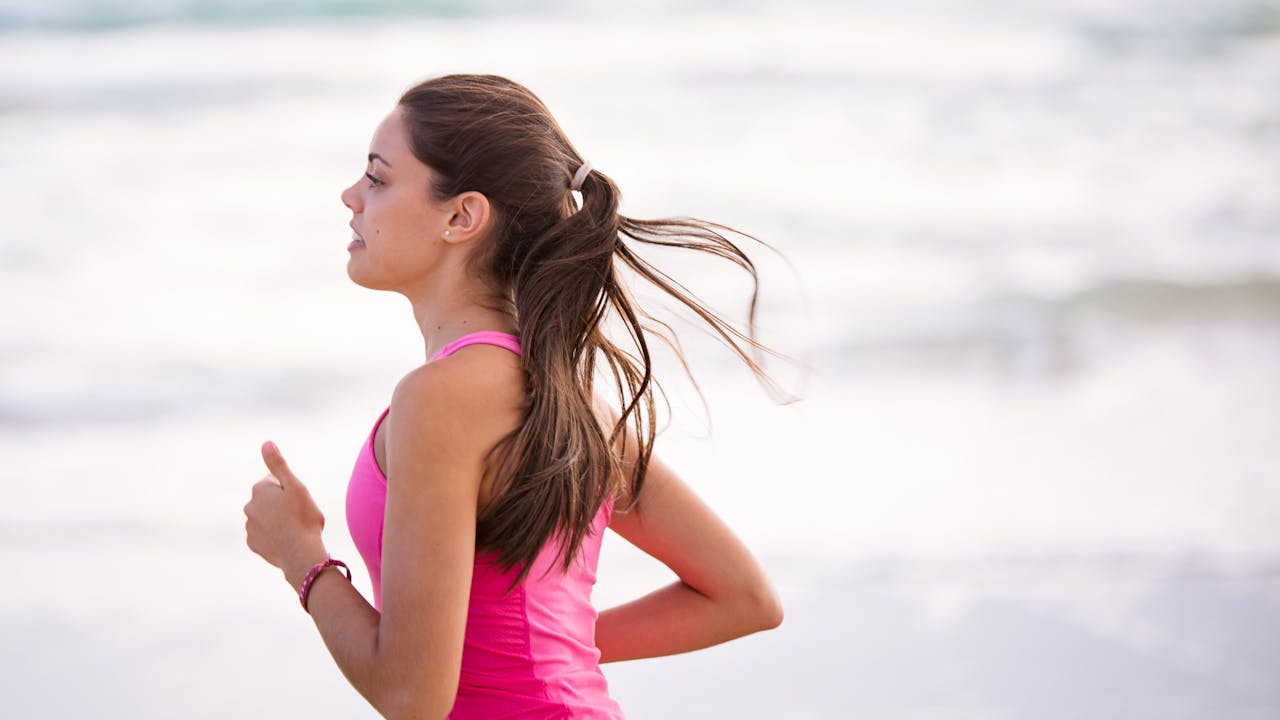 Active healthy older adult running outdoors in morning light, demonstrating cardiovascular vitality