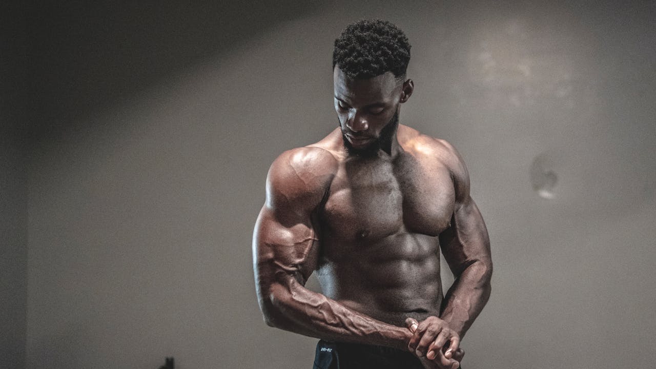Athlete mid-workout showing intense muscle exertion and physical performance