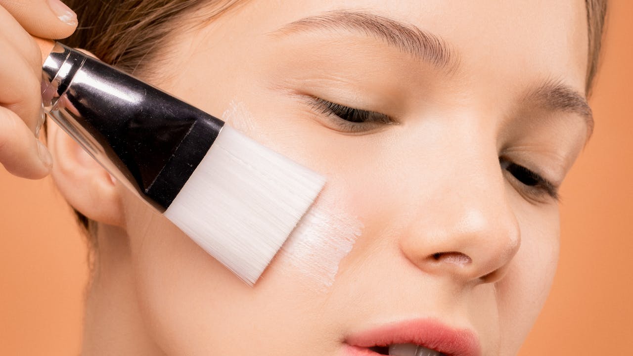 Person applying skincare lotion to arm, soft natural light, anti-aging skincare routine
