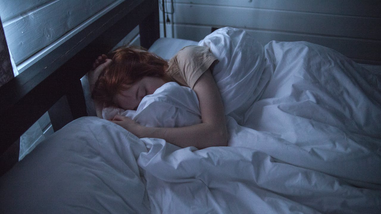 Person sitting by a window looking fatigued, representing the brain fog and fatigue of chronic Lyme disease