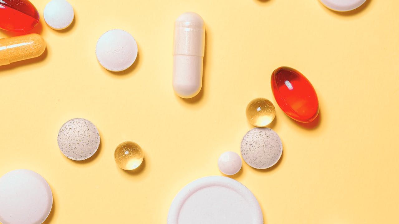 Collection of longevity supplements and biohacking tools on a clean white surface, warm natural light, modern wellness aesthetic