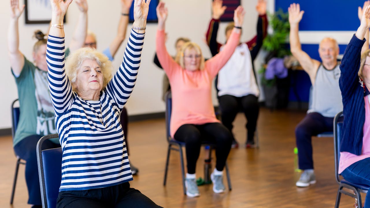 Active senior adults exercising outdoors representing healthy aging and longevity benefits