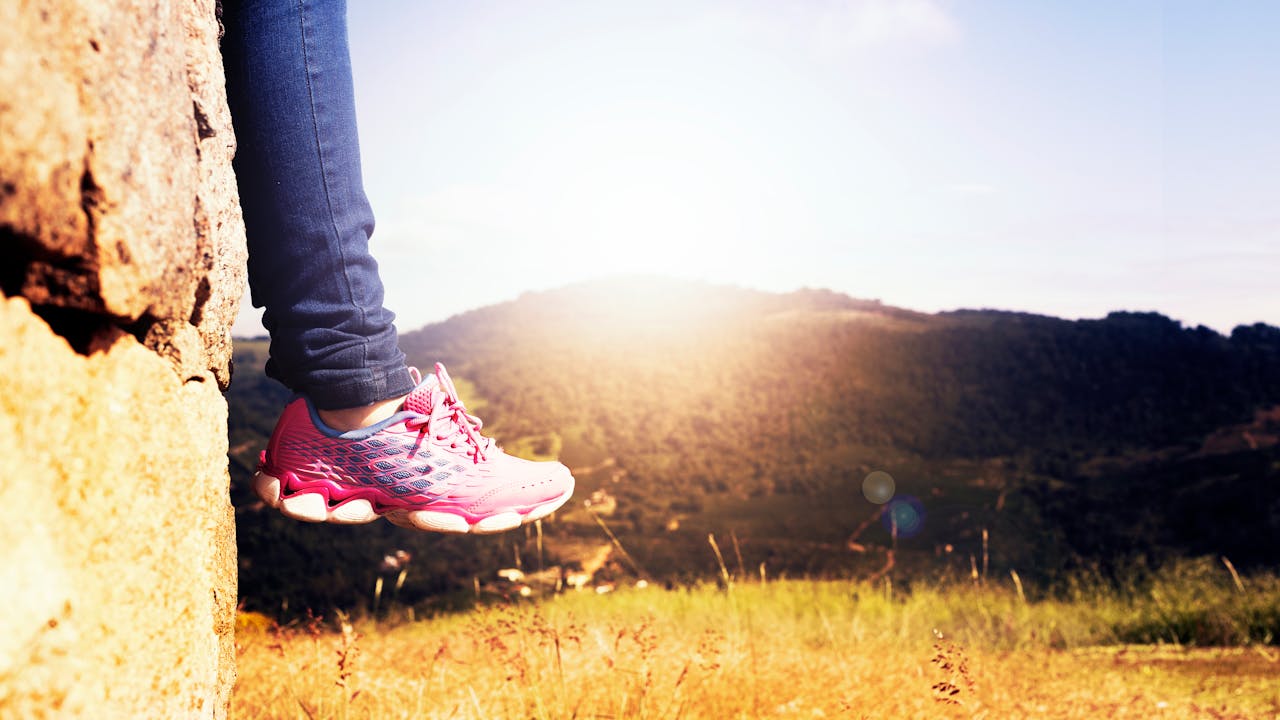 Active older adult hiking outdoors in morning light, healthy aging